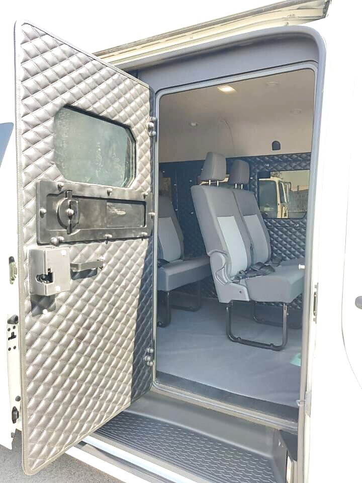 Open quilted side door panel of an armoured Hiace showing reinforced trim