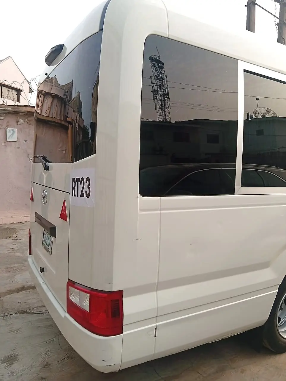 Rear-side view of the Toyota Coaster platform used for the armoured Coaster rental in Lagos