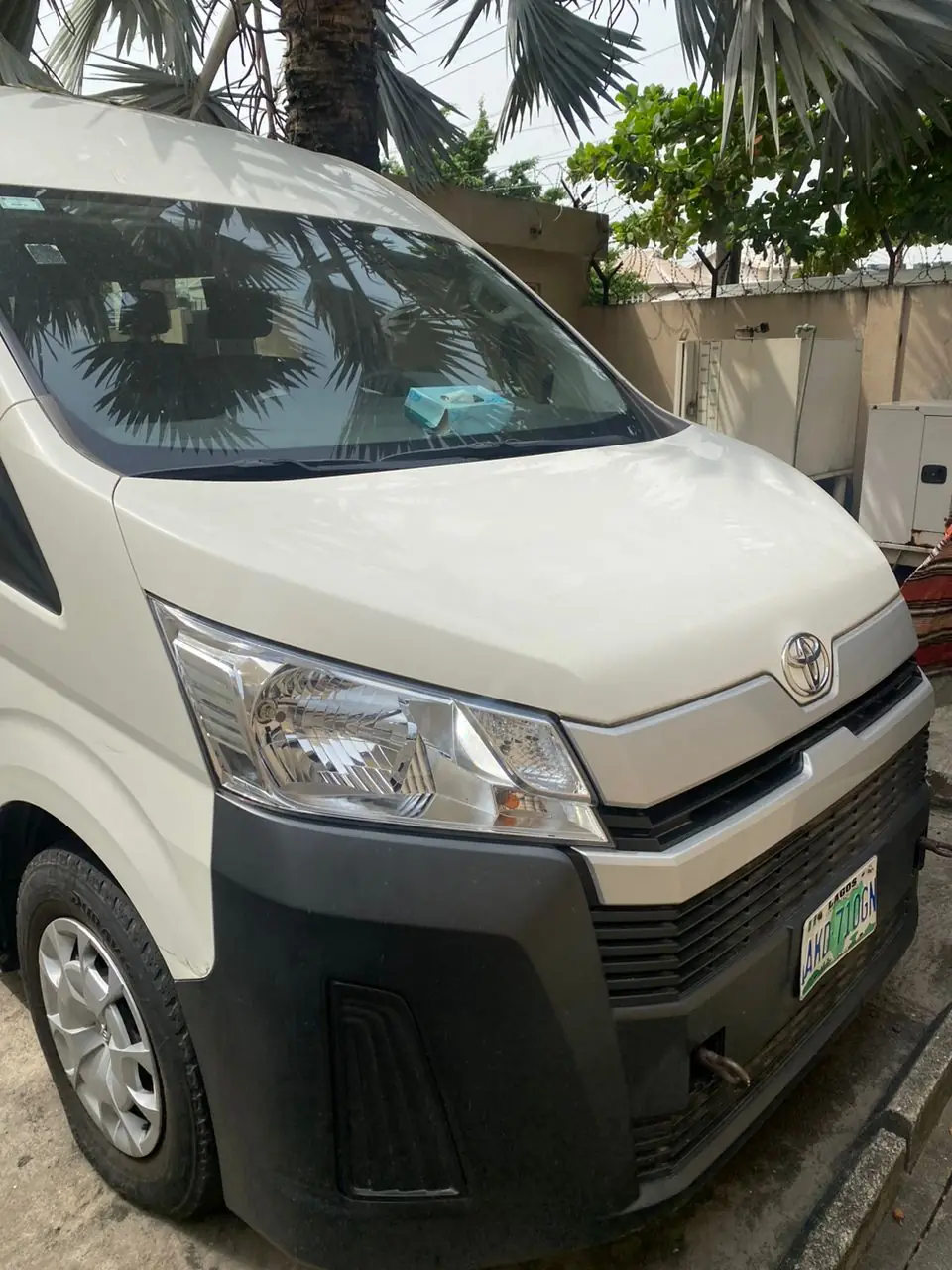Close-up front view of a white Toyota Hiace bus