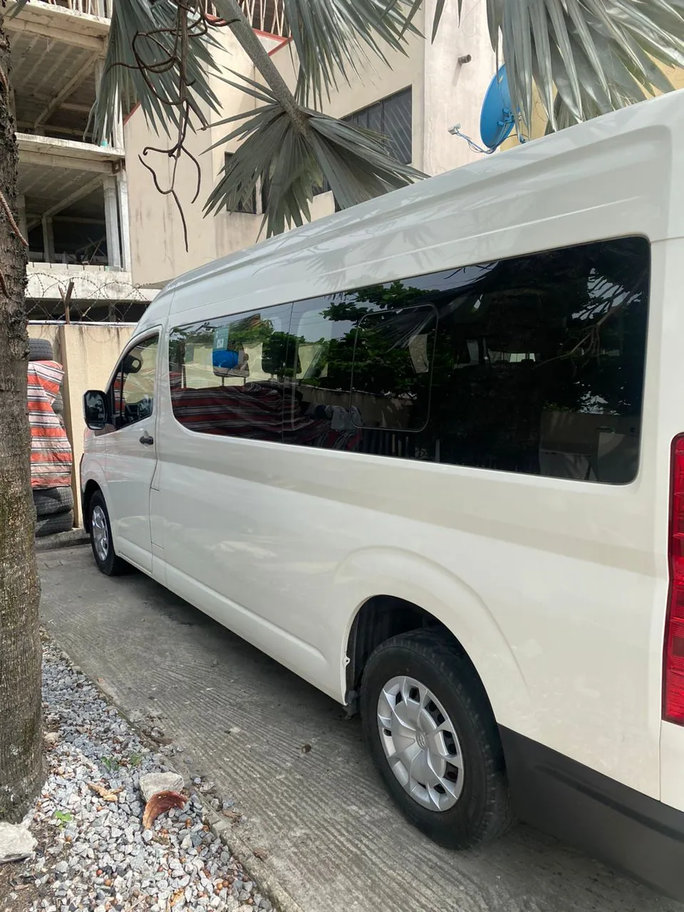 Side profile of a new-model white high-roof Toyota Hiace bus in Lagos