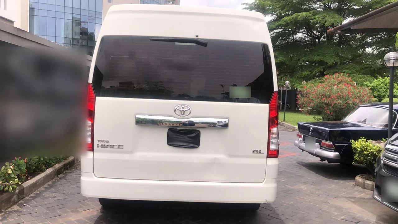 Rear view of a white Toyota Hiace GL bus in Lagos