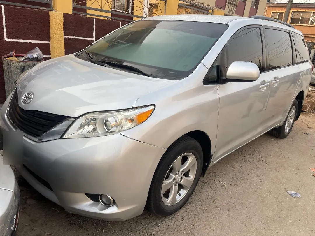 Silver Toyota Sienna for hire with a driver in Lagos, front three-quarter view
