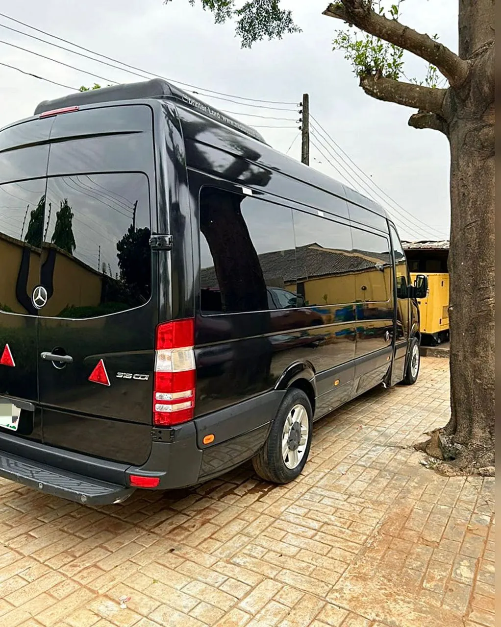 Rear side view of a black Mercedes-Benz Sprinter 316 CDI minibus in Lagos